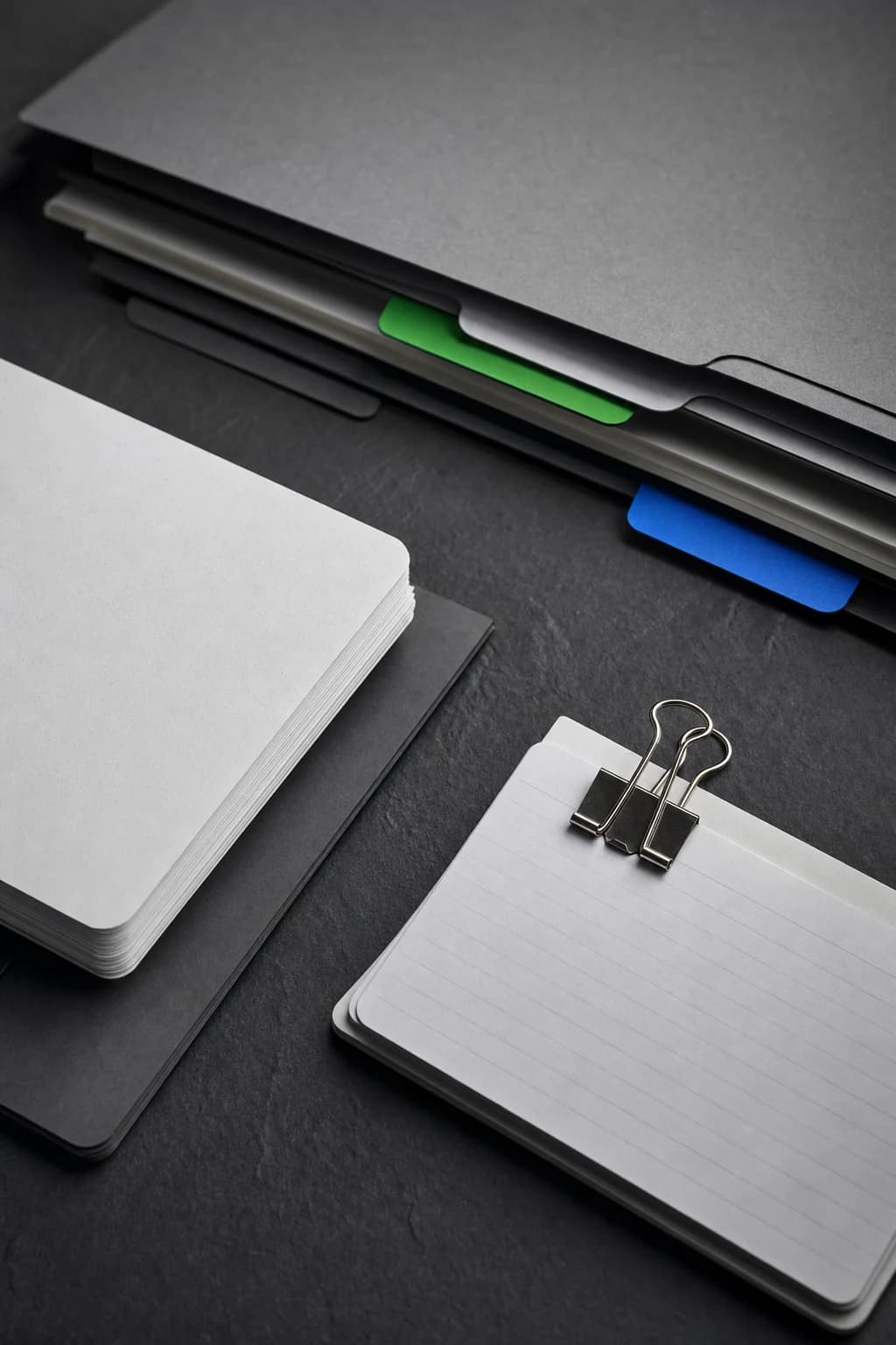 Organized project folders and index cards on a slate work surface